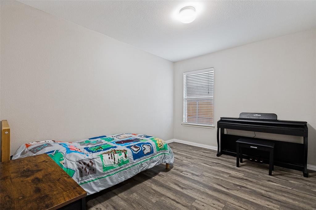 4305 Ridgewood Road Melissa, TX 75454 - Photo 19 of 26 Bedroom featuring wood-finish flooring, a window with blinds, and neutral wall paint