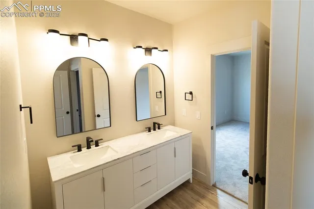 a bathroom with 2 sink and a mirror