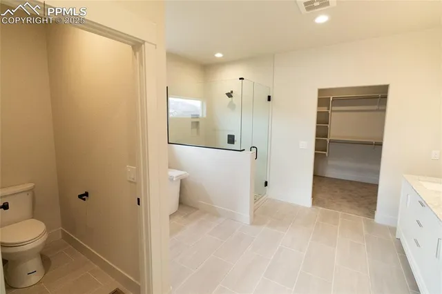 a bathroom with a tub shower sink and mirror