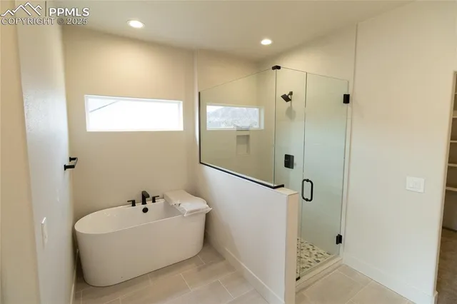 a spacious bathroom with double vanity and mirrors