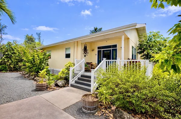 a front view of a house with a garden