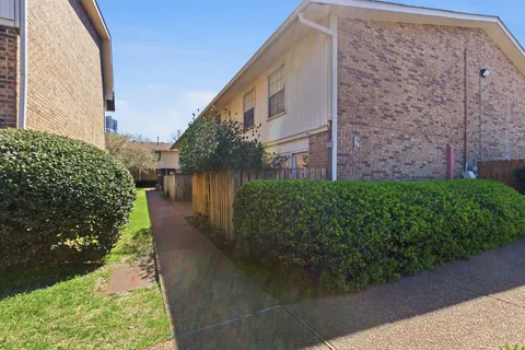 a pathway of a house with a yard