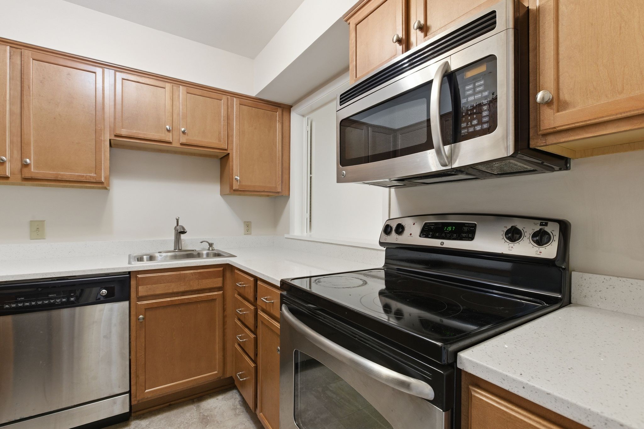 2116 Hobbs Road, Unit G6 Nashville, TN 37215 - Photo 12 of 30 a kitchen with stainless steel appliances a stove a microwave and cabinets
