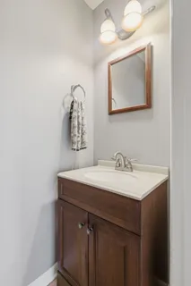 a bathroom with a sink vanity and a mirror