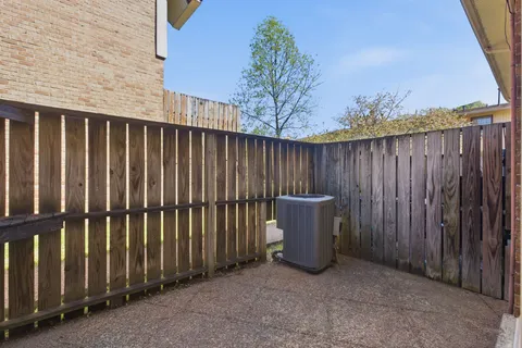 a view of a backyard with wooden fence