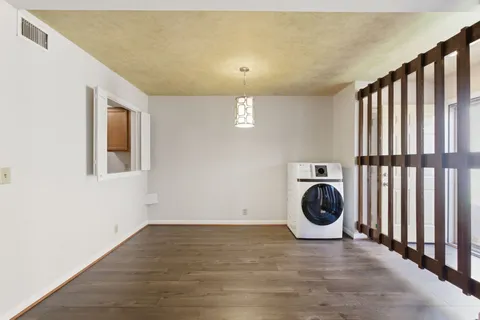 a view of a hallway with washer and dryer