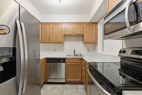 a kitchen with a sink appliances and cabinets