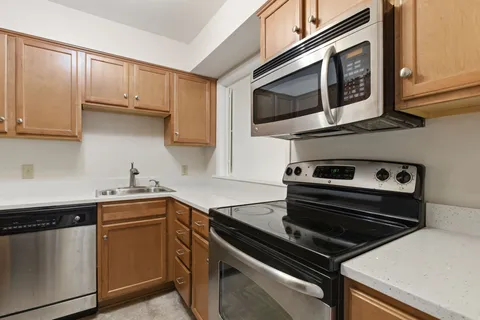 a kitchen with stainless steel appliances a stove a microwave and cabinets