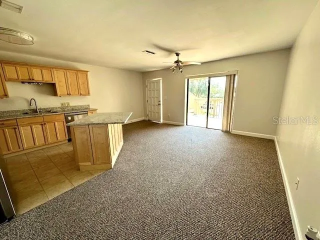 a view of a kitchen with furniture and a window
