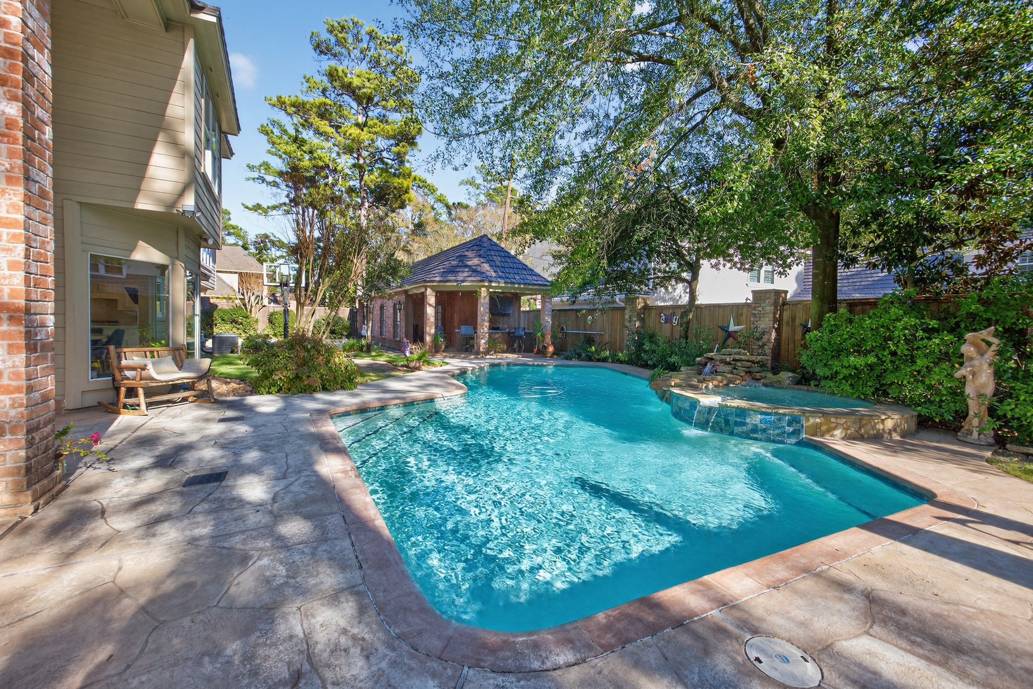 8807 Chelmsford Lane Spring, TX 77379 - Photo 43 of 50 Another look at the pool with the separate pool house & outdoor bar in the background.