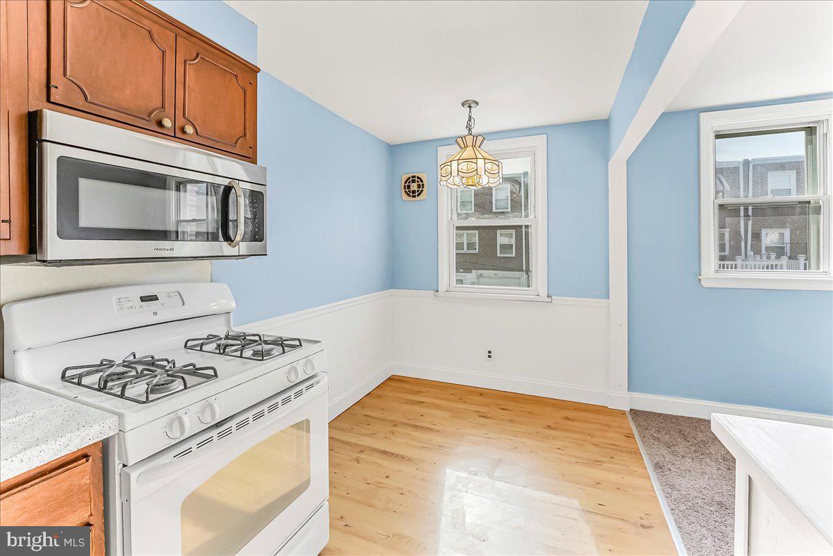 324 West Rively Avenue Glenolden, PA 19036 - Photo 13 of 27 a kitchen with stainless steel appliances granite countertop a stove microwave and cabinets
