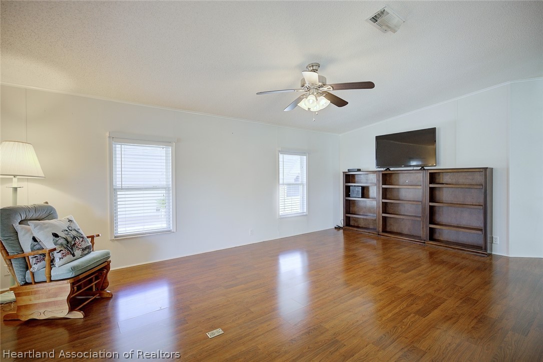 2702 Rodney Street Sebring, FL 33872 - Photo 2 of 33 a view of workspace with wooden floor and ceiling fan