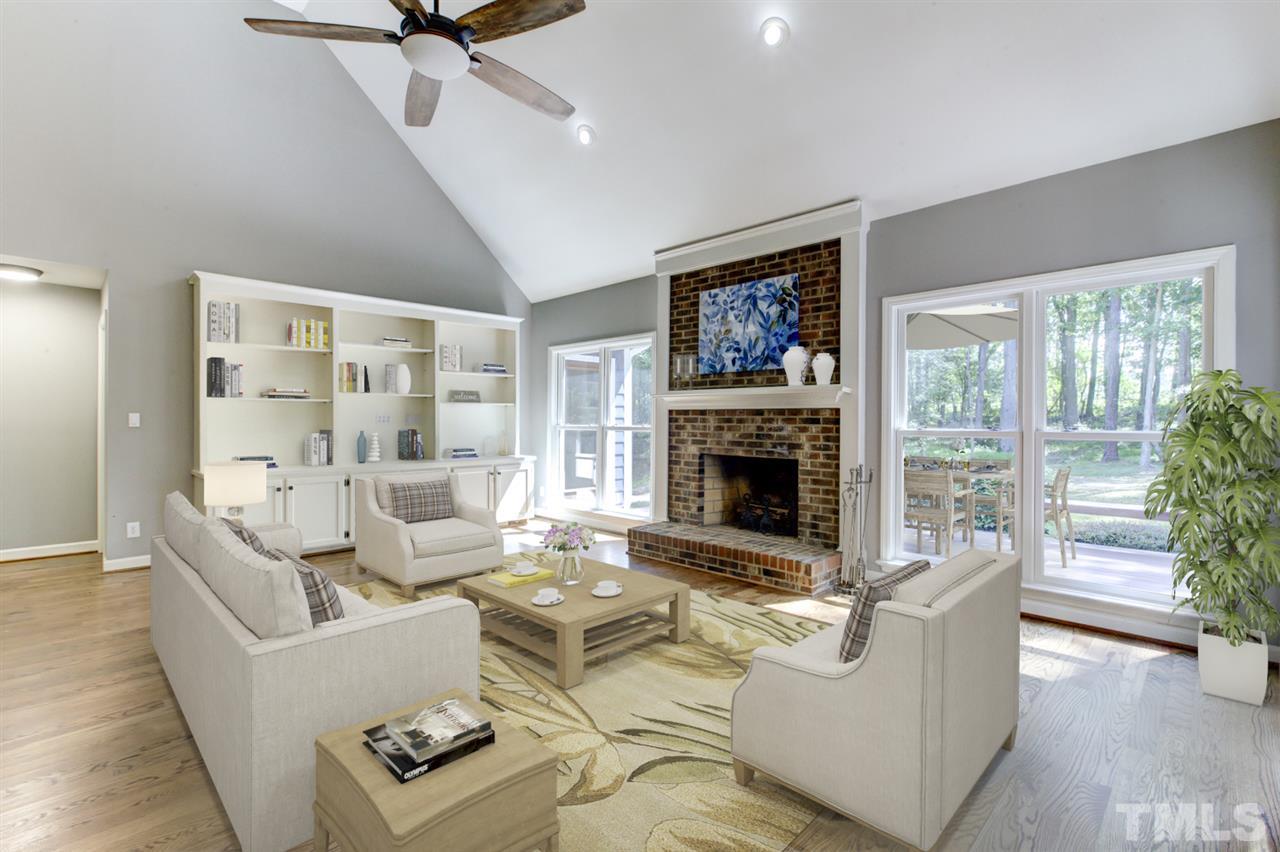 8228 Ridgeback Road Apex, NC 27523 - Photo 11 of 30 a living room with furniture large window and a fireplace