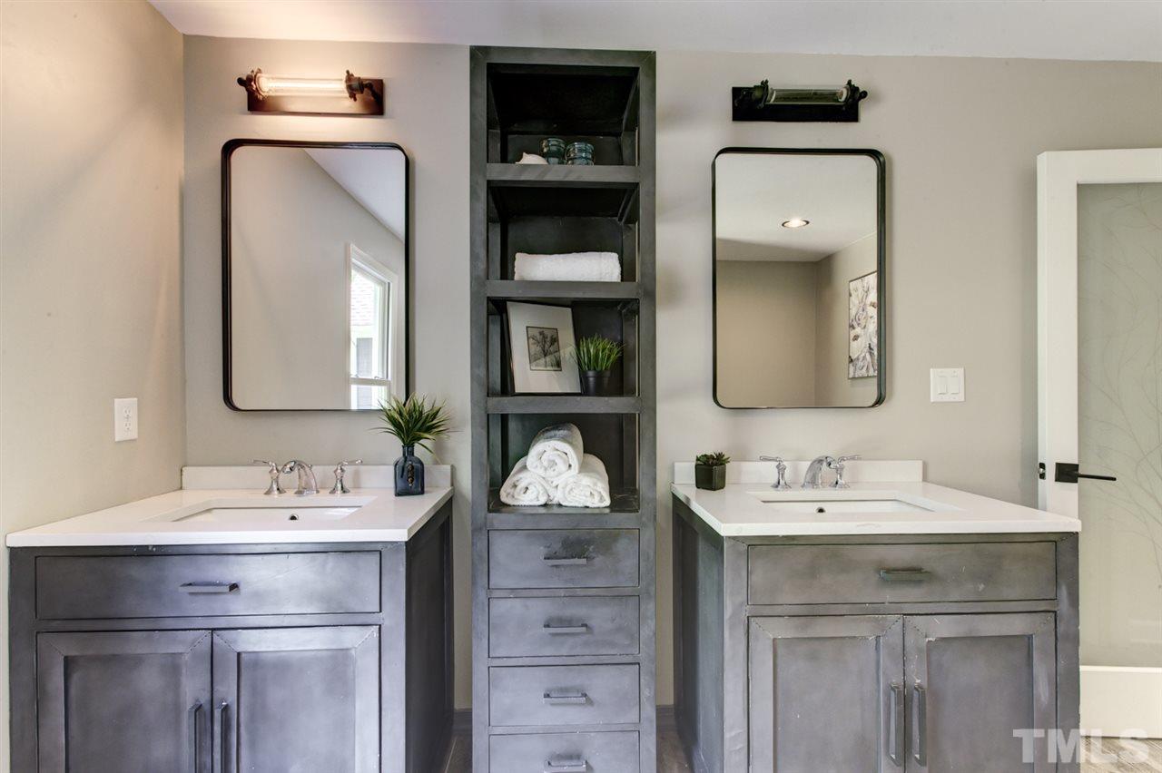 8228 Ridgeback Road Apex, NC 27523 - Photo 17 of 30 a bathroom with a double vanity sink and a mirror