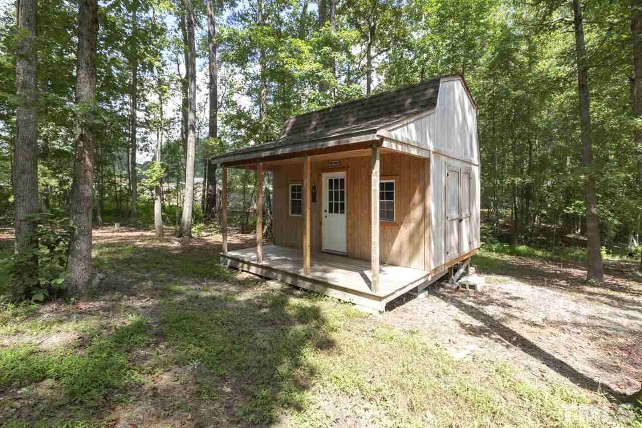 8228 Ridgeback Road Apex, NC 27523 - Photo 27 of 30 a view of a small house with yard and a tree