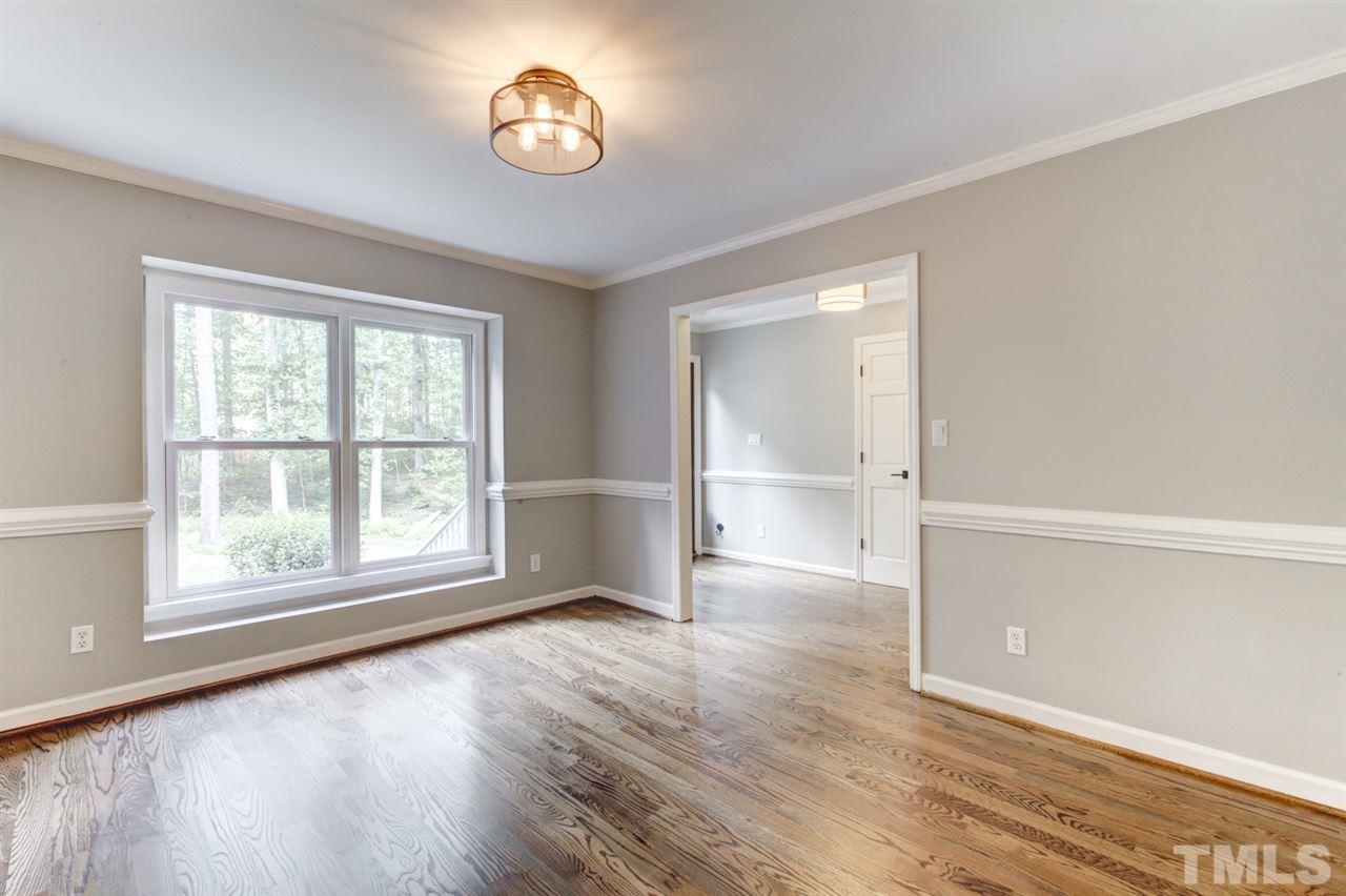 8228 Ridgeback Road Apex, NC 27523 - Photo 4 of 30 an empty room with wooden floor and windows