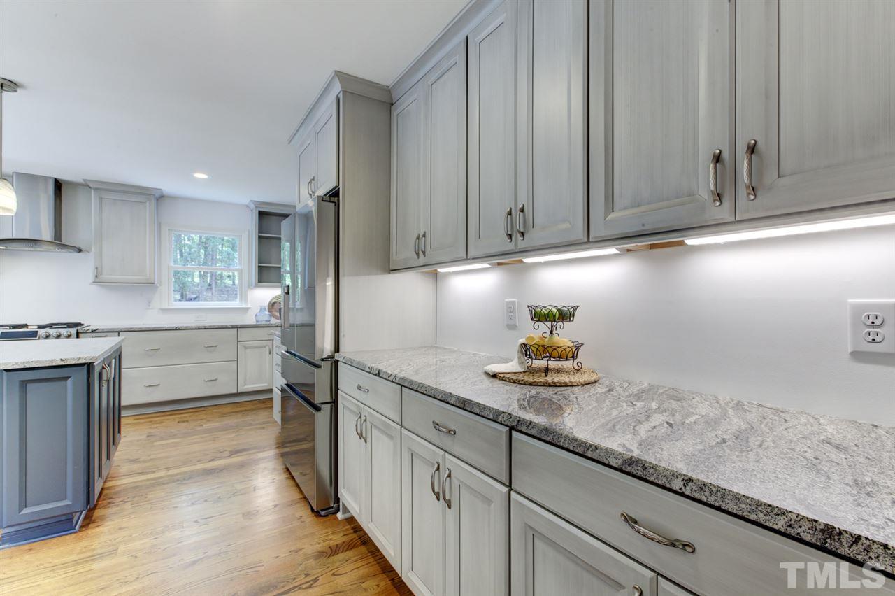 8228 Ridgeback Road Apex, NC 27523 - Photo 6 of 30 a kitchen with granite countertop a sink and cabinets