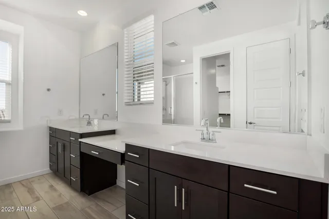a sink with a mirror and a vanity