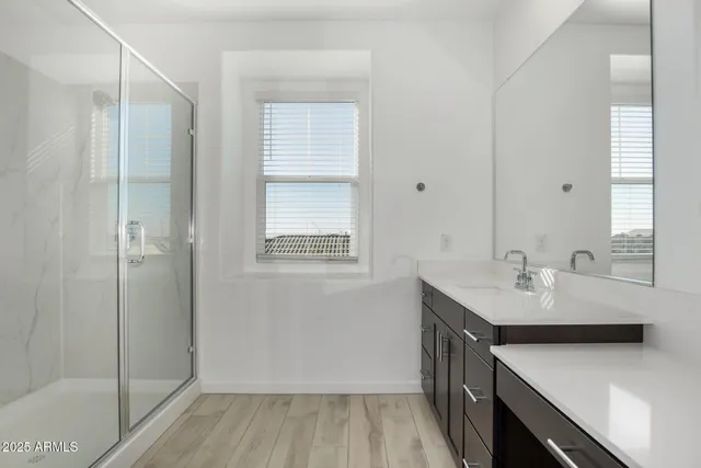 a kitchen with a sink cabinets and wooden floor