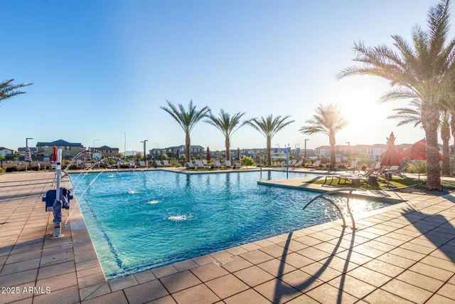 a view of swimming pool with outdoor seating and plants