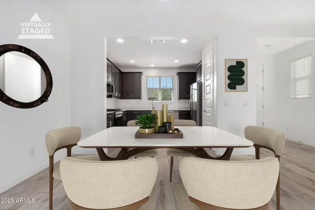 a dining room with furniture a mirror and wooden floor