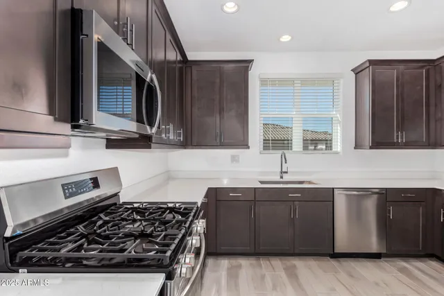a kitchen with wooden cabinets and a stove top oven