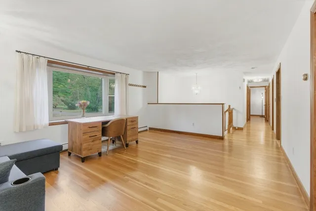 a view of a livingroom with furniture and a window