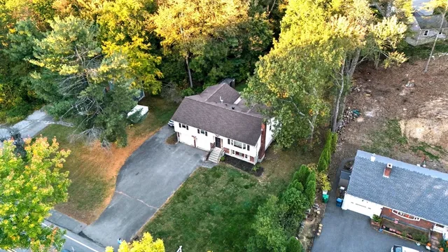 an aerial view of a house with a yard