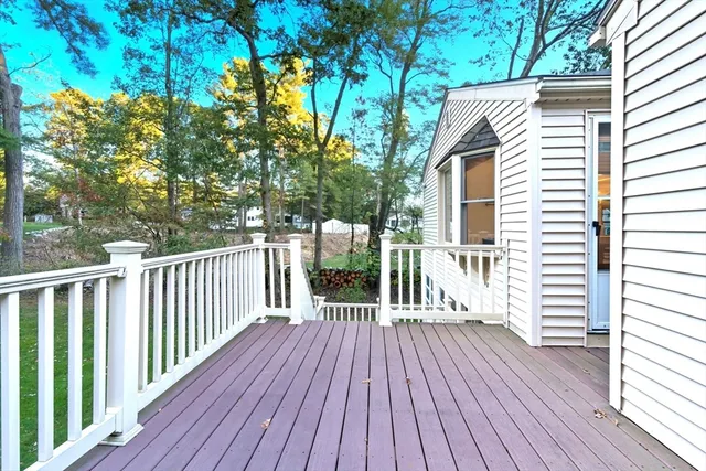 a view of a wooden deck with a yard