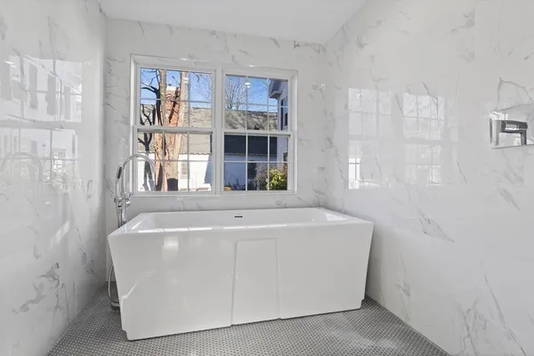 a white bath tub sitting in a bathroom