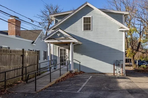 a view of a house with wooden fence