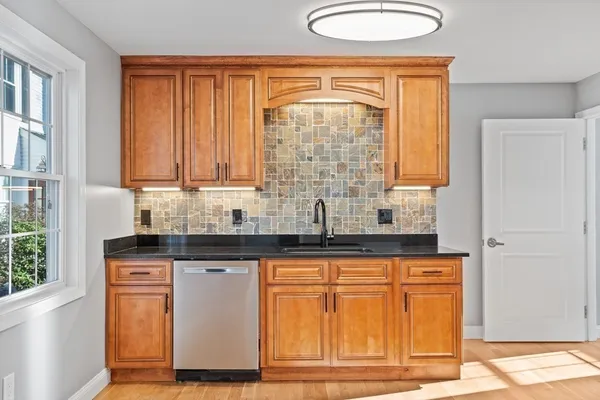a kitchen with granite countertop cabinets and window