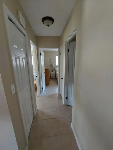a view of a hallway and a livingroom with furniture