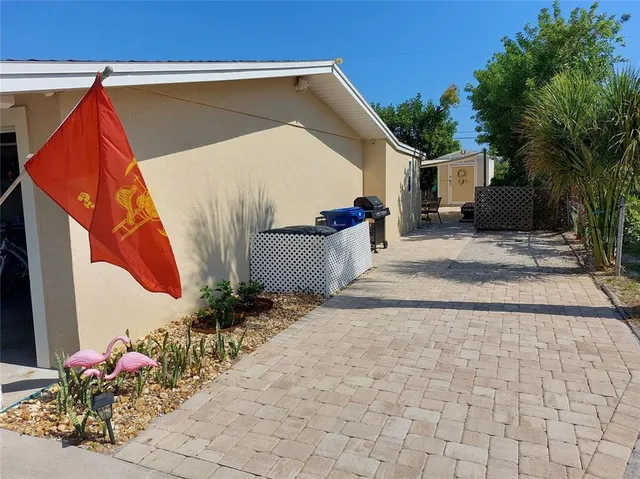 a view of a patio with plants and trees