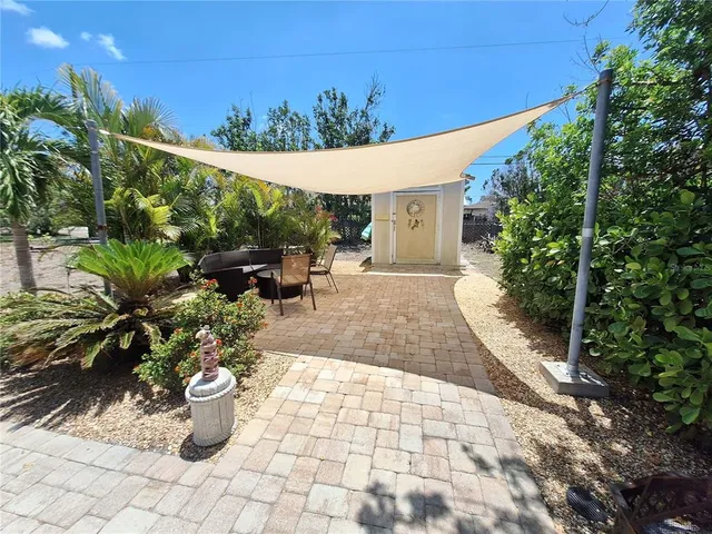 a view of a house with backyard and sitting area