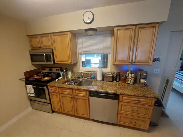a kitchen with sink a stove and cabinets