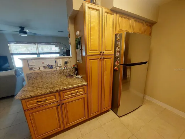 a kitchen with stainless steel appliances granite countertop a refrigerator and a stove