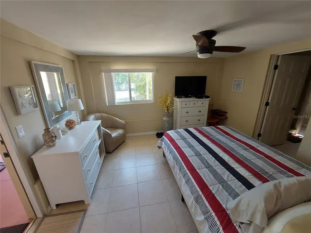 a bedroom with furniture and a flat screen tv