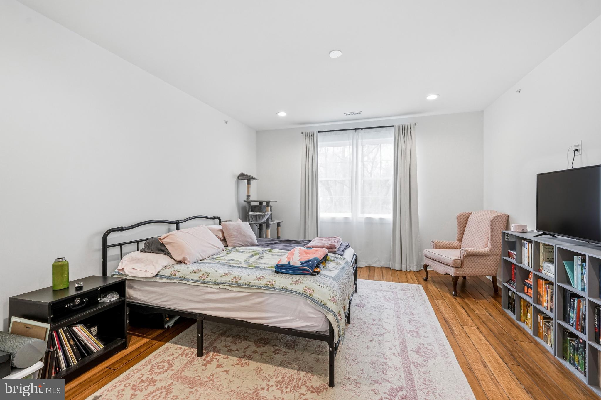 2604 Reed Street Philadelphia, PA 19146 - Photo 16 of 45 a bedroom with a bed and a bookshelf