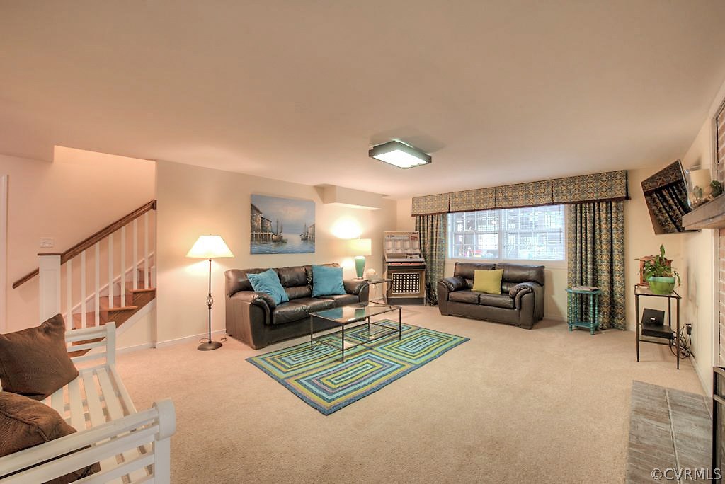10800 Ramshorn Road Midlothian, VA 23113 - Photo 33 of 49 a living room with furniture gym equipment and a flat screen tv