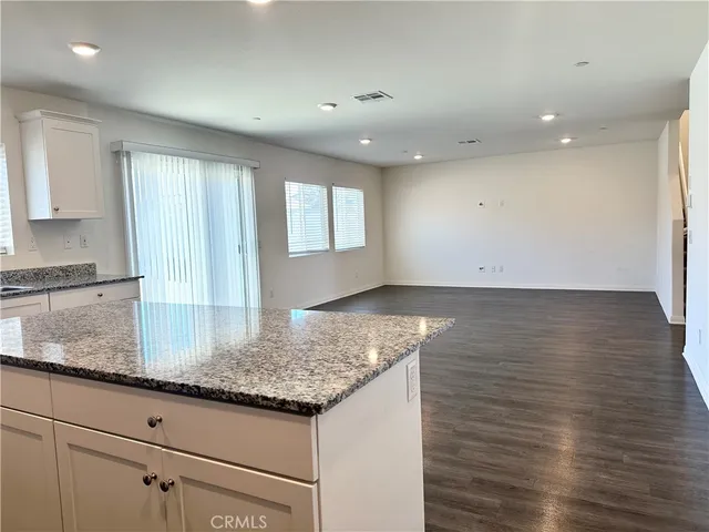 a kitchen with granite countertop sink and cabinets