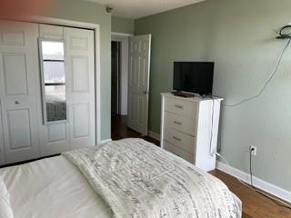 375 Ralph McGill Boulevard Northeast, Unit 1203 Atlanta, GA 30312 - Photo 11 of 12 a bedroom with a bed and a flat screen tv