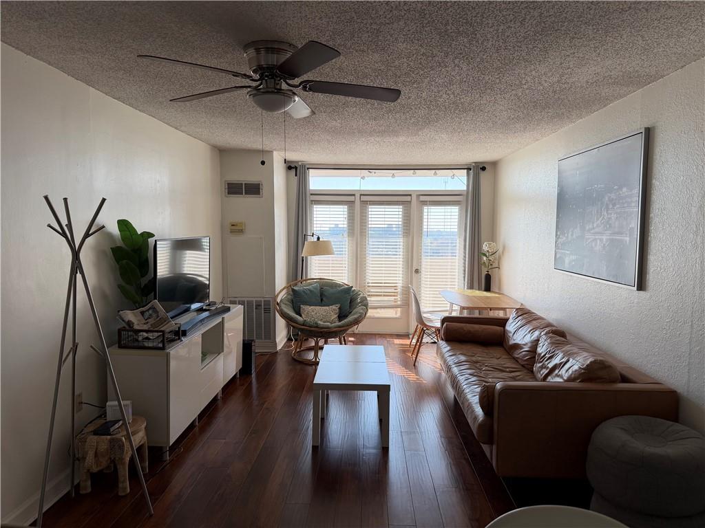 375 Ralph McGill Boulevard Northeast, Unit 1203 Atlanta, GA 30312 - Photo 2 of 12 a living room with furniture and a flat screen tv