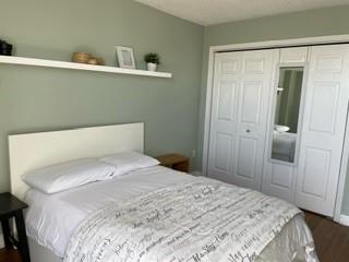 375 Ralph McGill Boulevard Northeast, Unit 1203 Atlanta, GA 30312 - Photo 10 of 12 a bedroom with a bed and a closet
