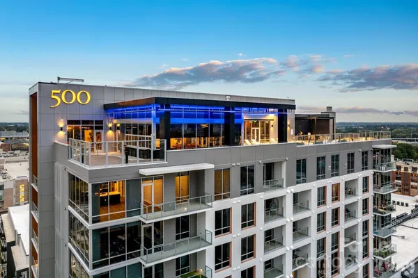 a spacious bedroom with a bed and a large mirror