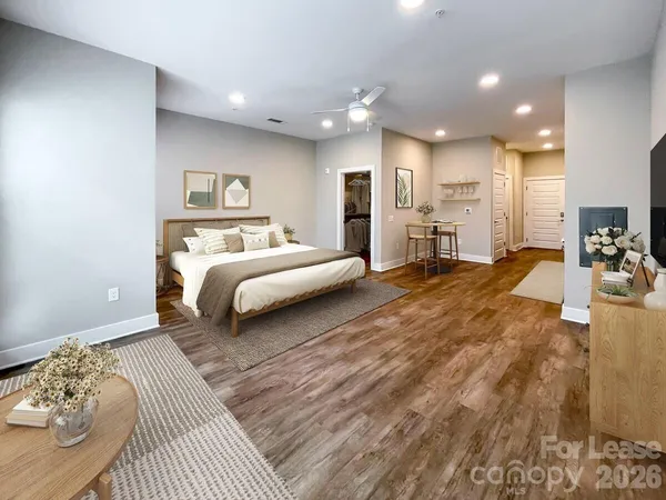 a spacious bedroom with a large bed and a window