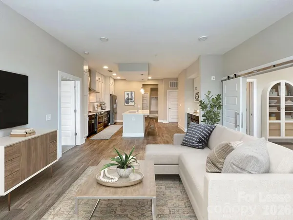 a kitchen with stainless steel appliances a counter space a sink a stove and a window