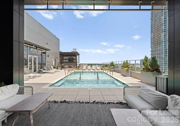 a swimming pool with outdoor seating and yard
