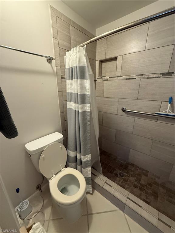 760 Augusta Boulevard, Unit D204 Naples, FL 34113 - Photo 28 of 32 a bathroom with a toilet and a shower