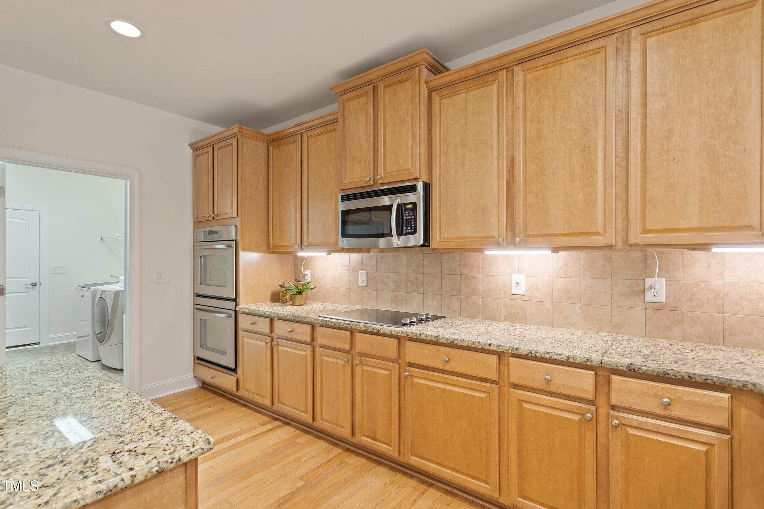 46 Spring Haven Lane Willow Spring, NC 27592 - Photo 13 of 45 a kitchen with stainless steel appliances granite countertop a sink a stove and a refrigerator